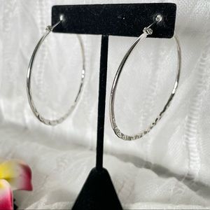 Large hoop shiny silver tone earrings